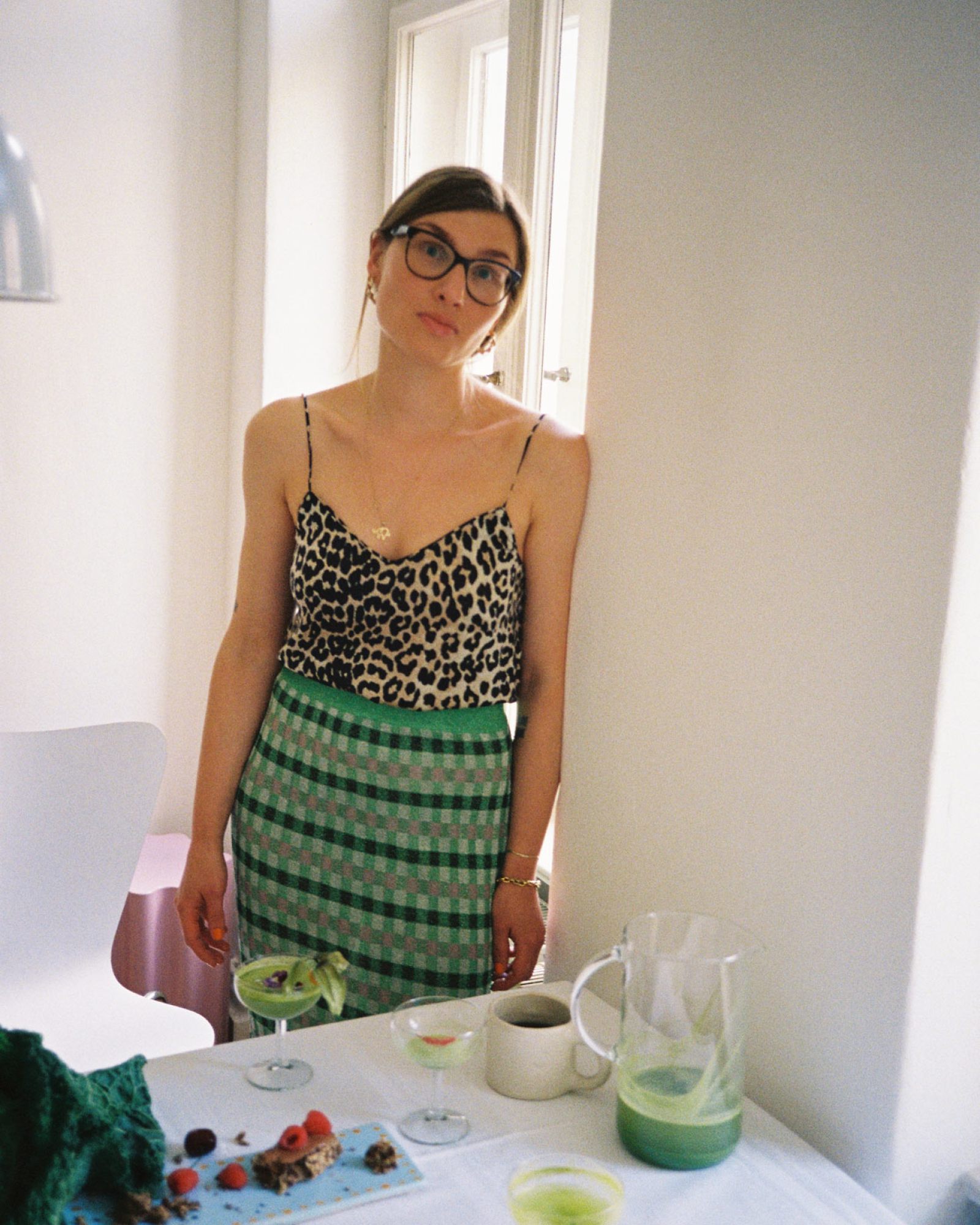 Michelle steht am Küchentisch mit frischem grünen Saft